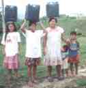 women carrying water from our well