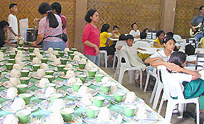 the kids having worship while their food is being put on plates