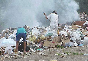 women scavenging for useable items in the dump